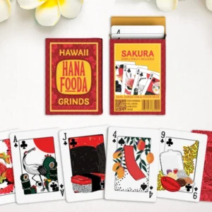 clean spread of the hanafuda card deck and the front and back of the box, with plumeria flowers framing the image