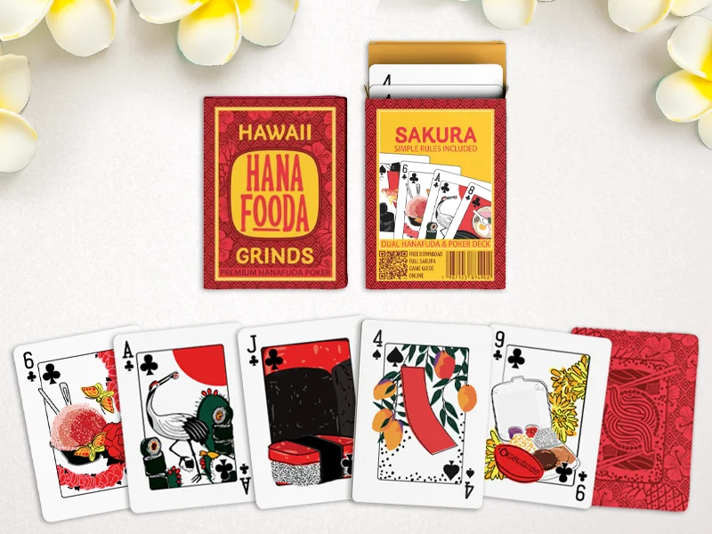 clean spread of the hanafuda card deck and the front and back of the box, with plumeria flowers framing the image